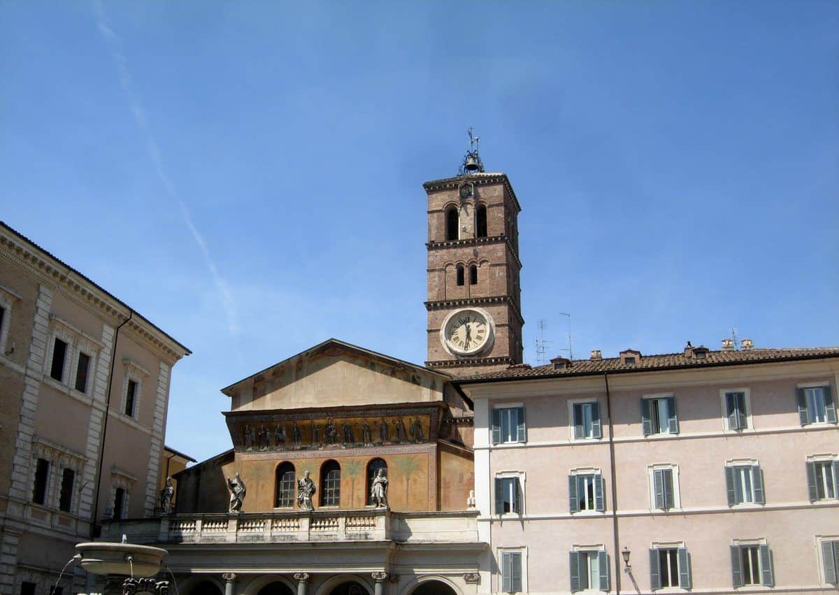 El campanario y la fachada de mosaicos de Santa Maria in Trastevere en su plaza, en Roma